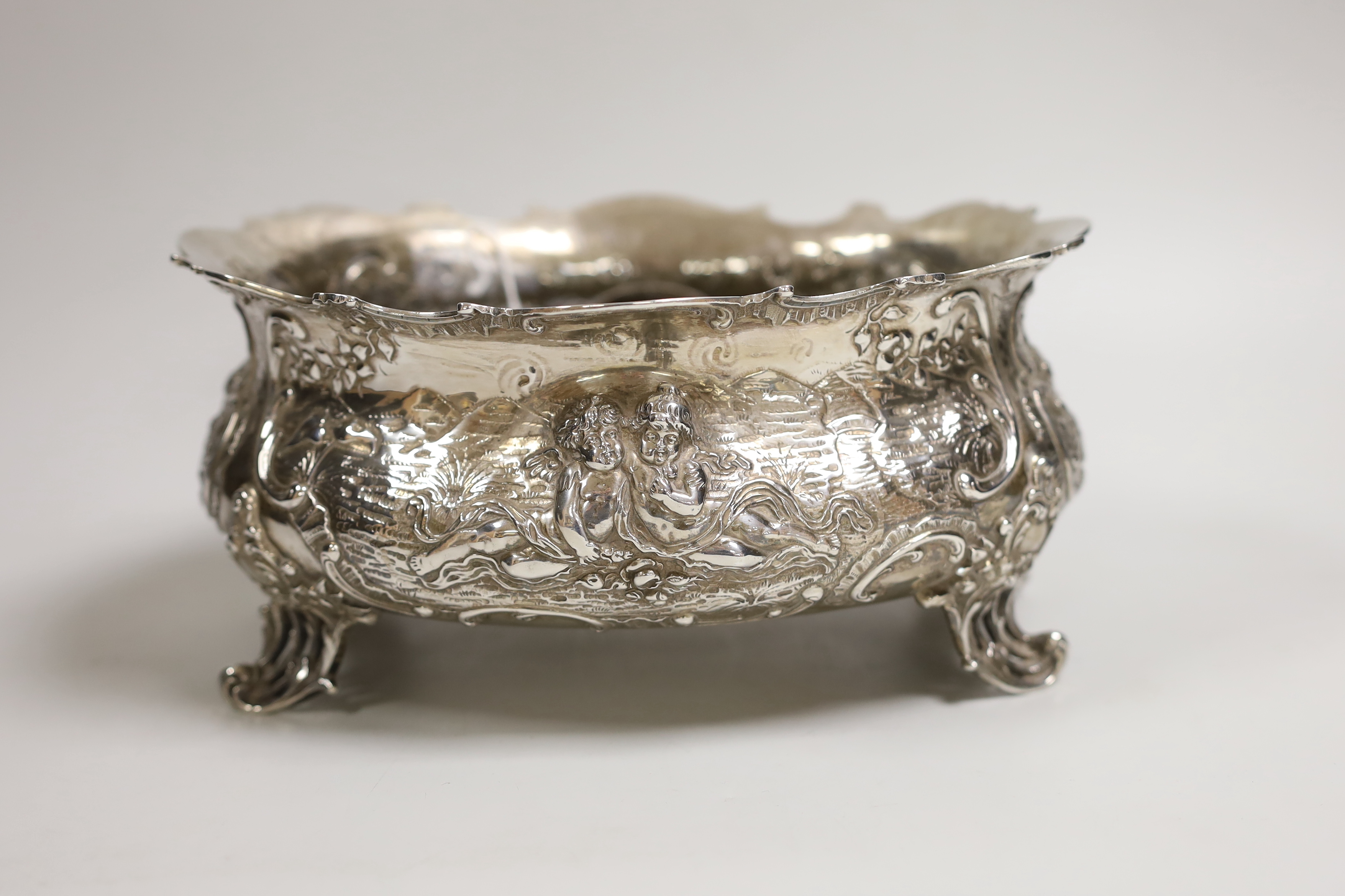 An ornate late 19th century German embossed silver oval fruit bowl, with pierced scroll feet, import marks for London, 1890, length 23.9cm, 30oz.